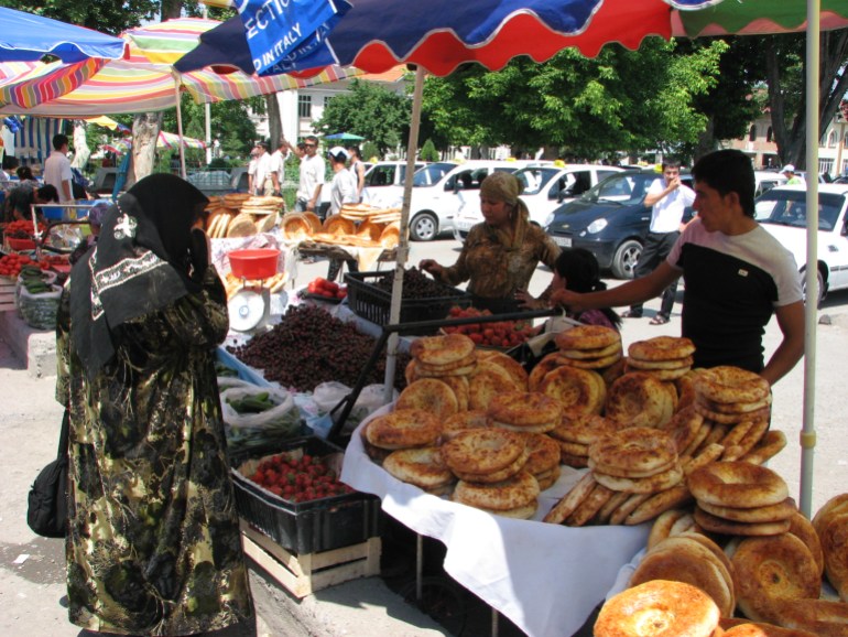 An Uzbek woman buys traditional bread in Ferghana, eastern Uzbekistan.