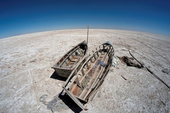 Boats are seen on the dried lake Poopo affected by climate change, in the Oruro Department, Bolivia in 2017