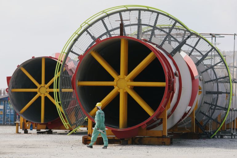 A worker walks past structural parts of an under construction oil refinery plant at Dangote refinery in Ibeju Lekki district, on the outskirts of Lagos, Nigeria August 7, 2019. Picture taken August 7, 2019 [Temilade Adelaja/Reuters]