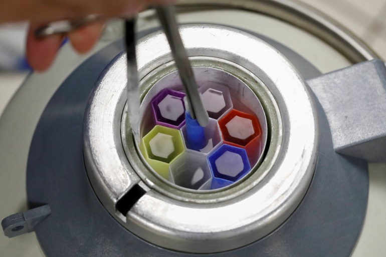 A medical technician prepares embryo and sperm samples