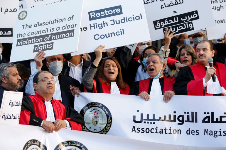 Tunisian judges display signs and banners during a protest against President Kais Saied's move to dissolve the Supreme Judicial Council, in Tunis, Tunisia, February 10, 2022