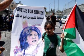 A Palestinian girl protests in support of slain Palestinian-American journalist Shireen Abu Akleh, as U.S. President Joe Biden visits Augusta Victoria Hospital, in Jerusalem, July 15, 2022