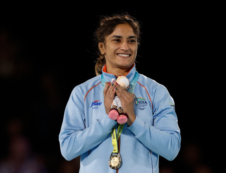 India's Vinesh Phogat celebrates with the gold medal 