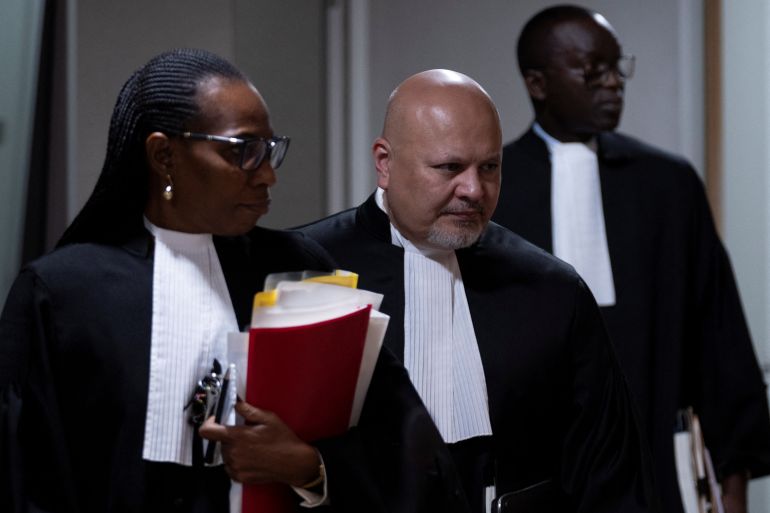 Public Prosecutor Karim Khan, centre, enters the court room for the trial of Mahamat Said Abdel Kani at the International Criminal Court in The Hague, Netherlands, Monday, Sept. 26, 2022. Peter Dejong/Pool via REUTERS