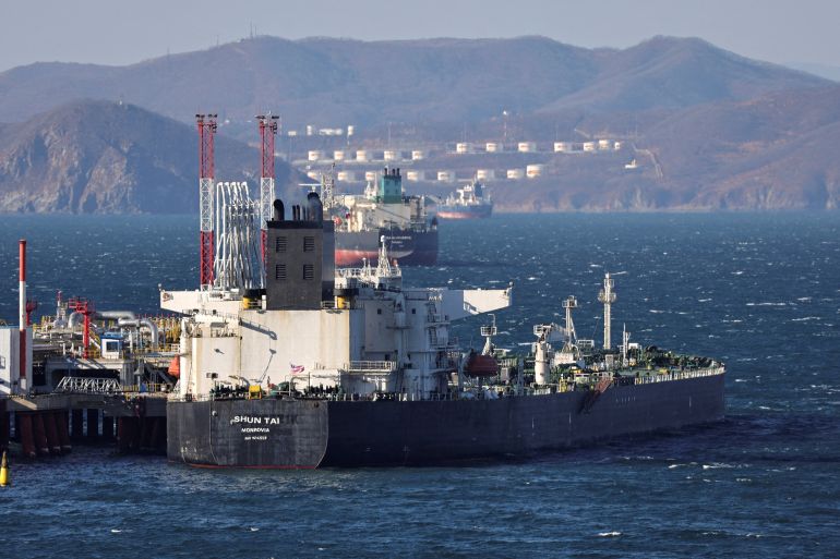 A crude oil tanker at the Kozmino terminal near Nakhodka in Russia. There are hills and gas storage tanks on the other side of the bay