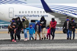 Guatemalan unaccompanied minors walk on the tarmac after arriving on a deportation flight from Mexico, at the Guatemalan Air Force (FAG) headquarters in La Aurora International Airport