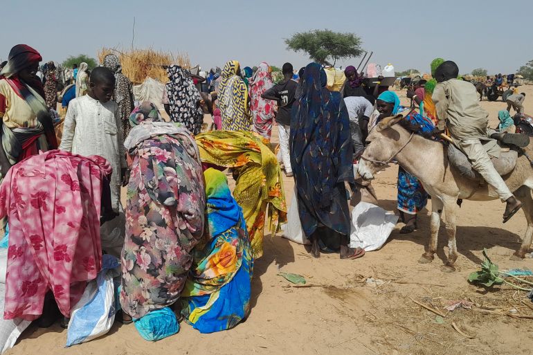 Sudanese refugees who fled the violence in their country, gather for food given by the World Food Programme (WFP) near the border between Sudan and Chad, in Koufroun, Chad April 28, 2023.