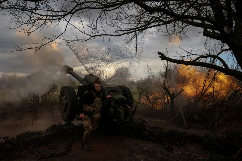 Ukrainian service members from a 3rd separate assault brigade of the Armed Forces of Ukraine, fire a howitzer D30 at a front line, amid Russia's attack on Ukraine, near the city of Bakhmut