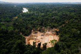 A helicopter of of the Brazilian environmental Agency (IBAMA) is seen near Uraricoera river during an operation at illegal mining in the Yanomami indigenous territory
