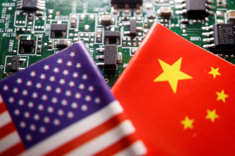 FILE PHOTO: Flags of China and U.S. are displayed on a printed circuit board with semiconductor chips, in this illustration picture taken February 17, 2023. REUTERS/Florence Lo/Illustration/File Photo