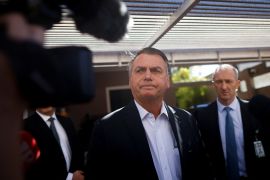 Former Brazil president Jair Bolsonaro speaks to reporters outside his residence in Brasilia