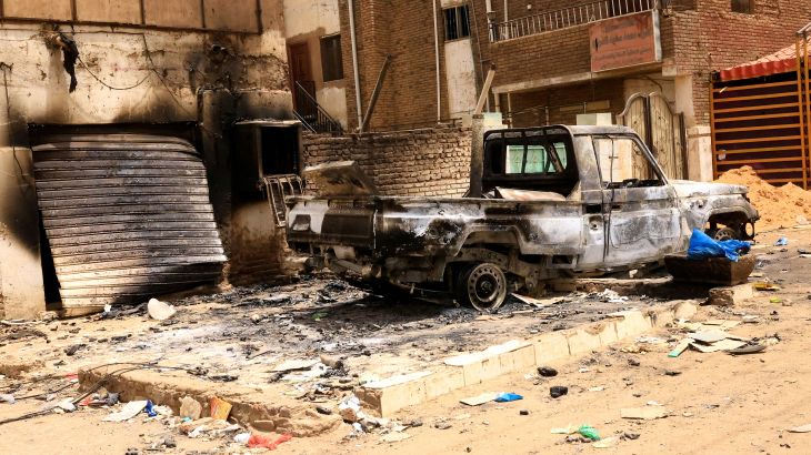Damaged buildings and burned-out pickup truck are seen at the central market during clashes between the paramilitary Rapid Support Forces and the army in Khartoum North, Sudan.