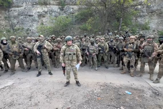 The founder of the Wagner private mercenary group, Yevgeny Prigozhin, makes a statement as he stands next to Wagner fighters in an undisclosed location in the course of the Russia-Ukraine conflict, in this still image taken from video released May 5, 2023.