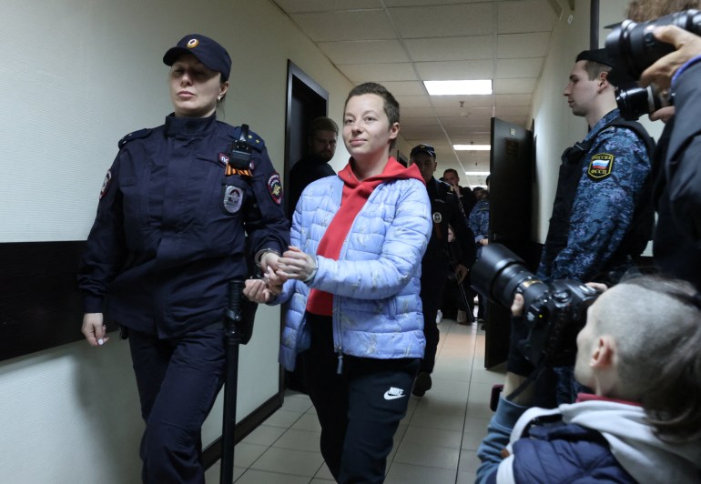 Russian theatre director Yevgenia Berkovich, detained on suspicion of justifying terrorism, is escorted before a court hearing in Moscow, Russia May 5, 2023.