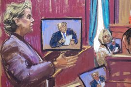 A courtroom sketch, showing a woman in a purple suit standing and speaking, while monitors show an image of Donald Trump and E Jean Carroll sits nearby