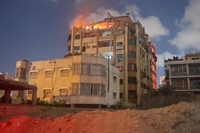 A fire at the top of a building is seen following an explosion in Gaza, May 9, 2023. 