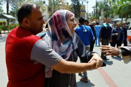Palestinians react following a deadly Israeli strike in the southern Gaza Strip