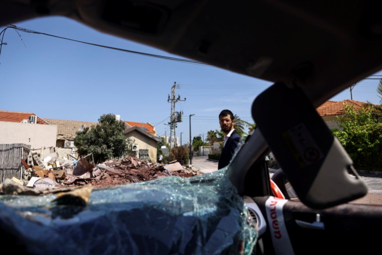 A view taken from the inside of a car shows the area outside a home that was damaged when a rocket, fired from Gaza landed in Ashkelon