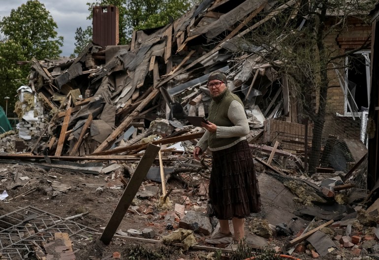 Person stands in the middle of a destroyed building
