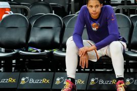 Brittney Griner sits on a bench ahead of a pre-season WNBA game with the Phoenix Mercury