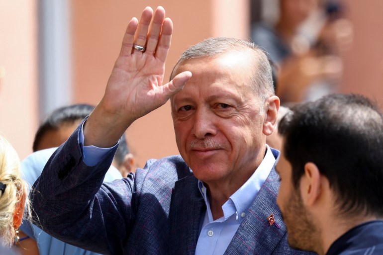 Turkish President Recept Tayyip Erdogan waves to someone.