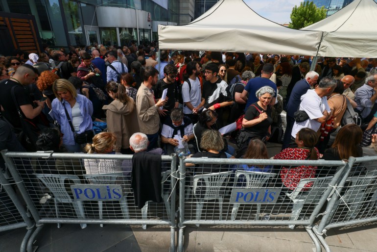 People gather outside a polling station during Turkish presidential and parliamentary elections, in Ankara.