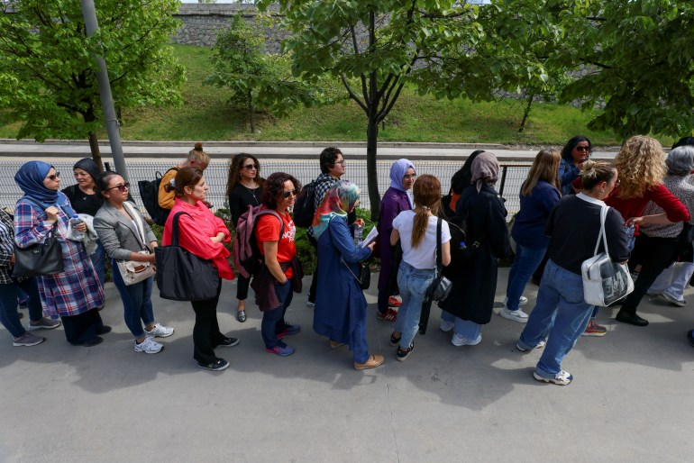 People queue outside a polling station during Turkish presidential and parliamentary elections, in Ankara.