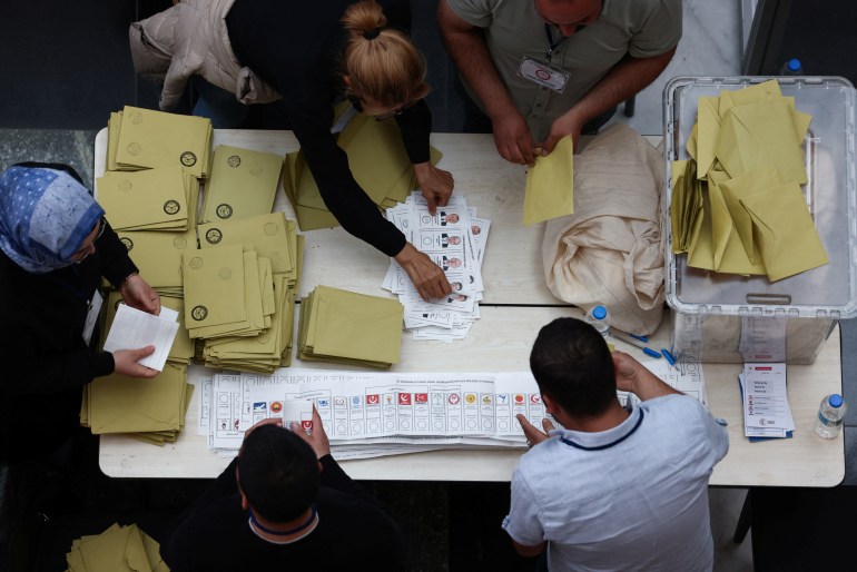 Staff work as they count ballots at a polling station in Ankara, Turkey.