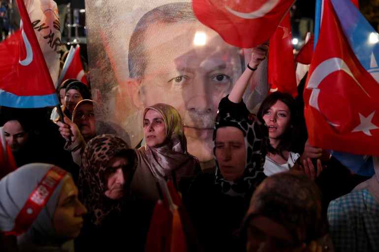 Supporters of Turkish President Recep Tayyip Erdogan and AK Party (AKP) wave flags at the AK Party headquarters in Ankara, Turkey