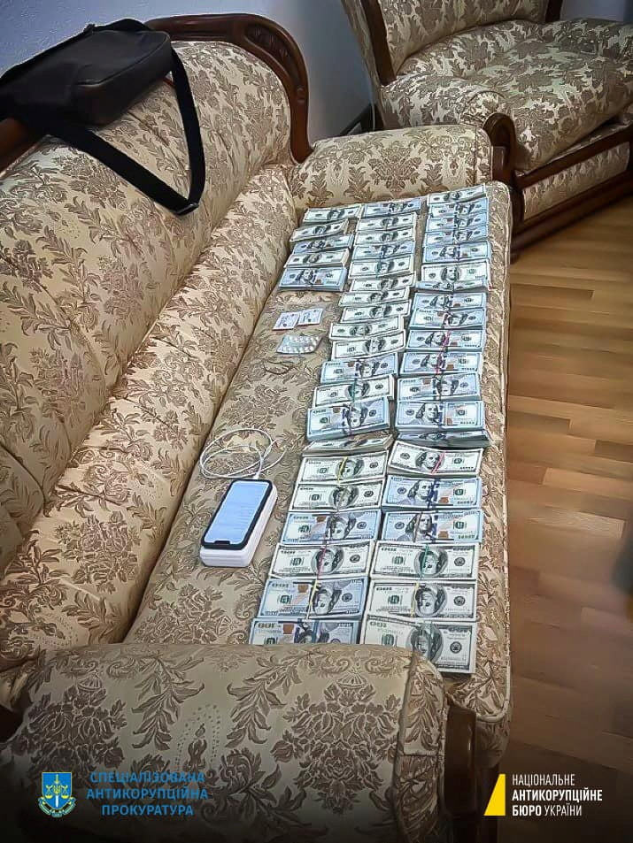 Piles of cash lined up by Ukrainian prosecutors.