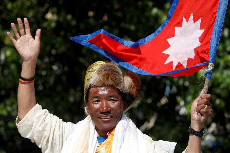 Nepali mountaineer Kami Rita Sherpa waves upon his arrival after climbing Mount Everest for the 24th time in 2019, setting a record for the most summits of the world's highest mountain, in Kathmandu, Nepal