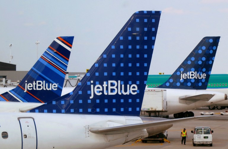 The tail end of several JetBlue planes, where the company's logo can be seen against patterned backgrounds.