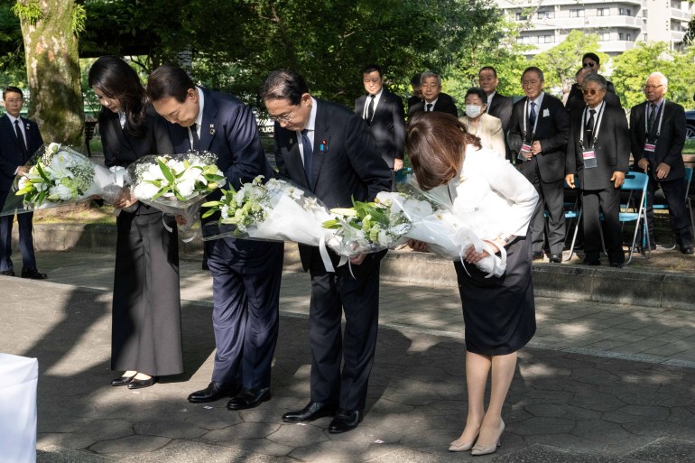 South Korea's Yoon Suk-yeol, his wife Kim Keon-hee, Japan's Prime Minister Fumio Kishida and his wife Yuko Kishida bow as they lay flowers at the "Monument in Memory of the Korean Victims of the A-bomb", near the Peace Park Memorial in Hiroshima, Japan on May 21, 2023, on the sidelines of the G7 Summit Leaders' Meeting.