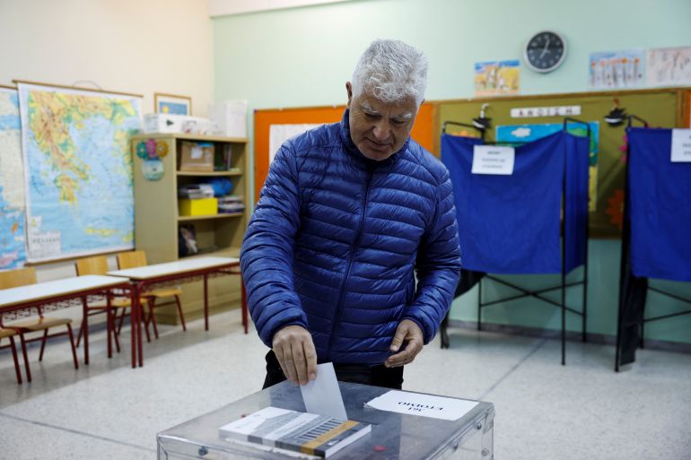 A man casts his vote at a polling station, during the general election