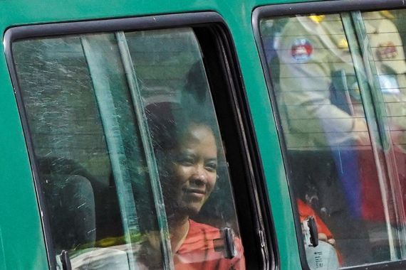 Chhim Sithar leaving in Phnom Penh court in a green prison minibus.