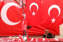 A man sells Turkish flags before Turkey&#39;s May 28 presidential run-off vote, in Ankara, Turkey, May 27, 2023 [Yves Herman/Reuters]