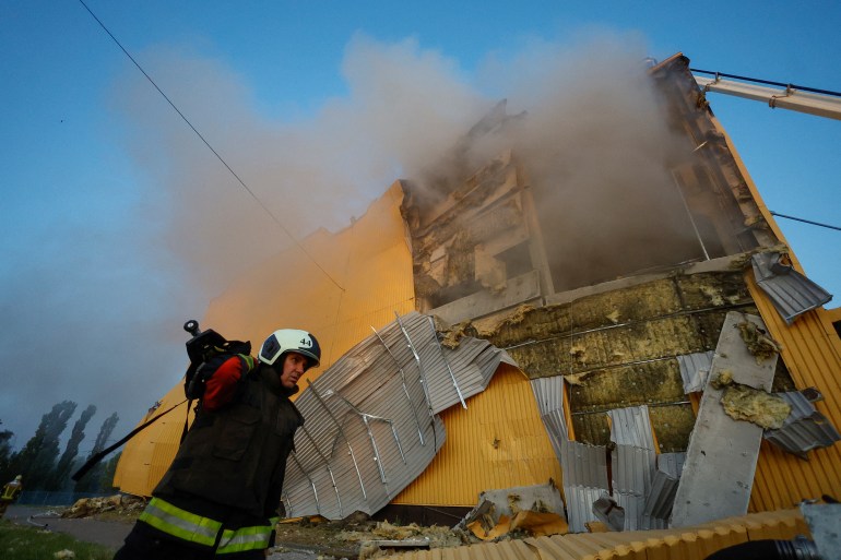 A firefighter works at a site of a tobacco factory damaged during Russian suicide drone strike, amid Russia's attack on Ukraine, in Kyiv, Ukraine May 28, 2023. REUTERS/Valentyn Ogirenko.