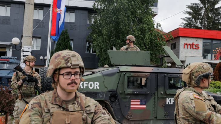 U.S. KFOR soldiers stand guard in front of the municipality office, while ethnic Serbs gather to protest, in the town of Leposavic, Kosovo, May 29, 2023.