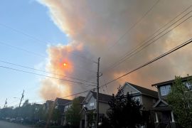 Smoke from a wildfire in Nova Scotia rises over homes in nearby Bedford, Canada