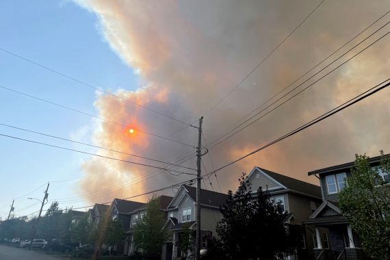 Smoke from a wildfire in Nova Scotia rises over homes in nearby Bedford, Canada