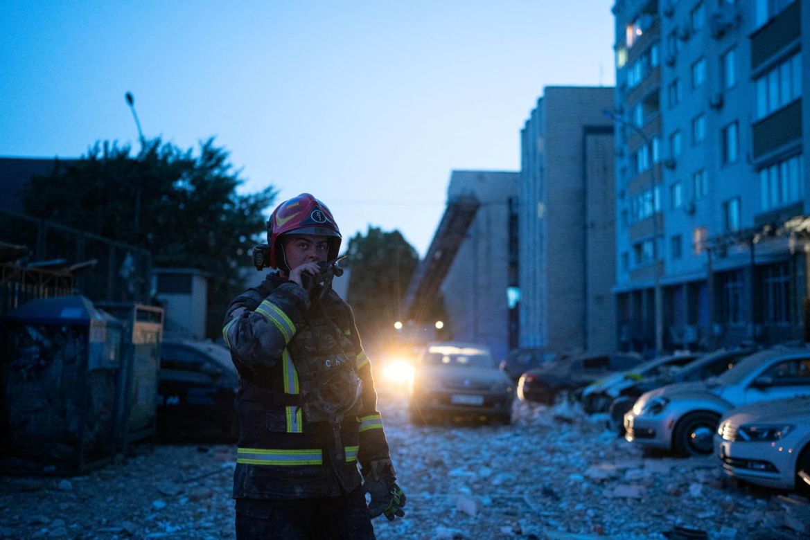 A rescuer works at the area where an apartment building has been damaged