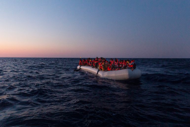 This handout picture taken and released on July 23, 2022 by the NGO Sea-Watch shows a Sea-Watch 3 crew member on a lifeboat approaching an inflatable boat in distress with 120 people on board in the central Mediterranean. (Photo by Nora Börding / SEA-WATCH / AFP) / RESTRICTED TO EDITORIAL USE - MANDATORY CREDIT "AFP PHOTO /SEA-WATCH / NORA BORDING " - NO MARKETING - NO ADVERTISING CAMPAIGNS - DISTRIBUTED AS A SERVICE TO CLIENTS - RESTRICTED TO EDITORIAL USE - MANDATORY CREDIT "AFP PHOTO /Sea-Watch / NORA BORDING " - NO MARKETING - NO ADVERTISING CAMPAIGNS - DISTRIBUTED AS A SERVICE TO CLIENTS /