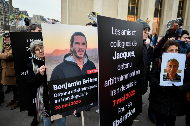 Demonstrators hold portraits of Benjamin Briere