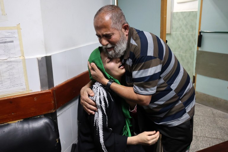 Relatives of Palestinian Islamic Jihad leader Jihad al-Ghannam, killed by an Israeli air raid at his home, mourn at Alnajjar hospital in Rafah refugee camp, southern Gaza Strip.