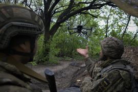 Ukrainian servicemen of a Reconnaissance team fly a drone at a front line near the town of Bakhmut.
