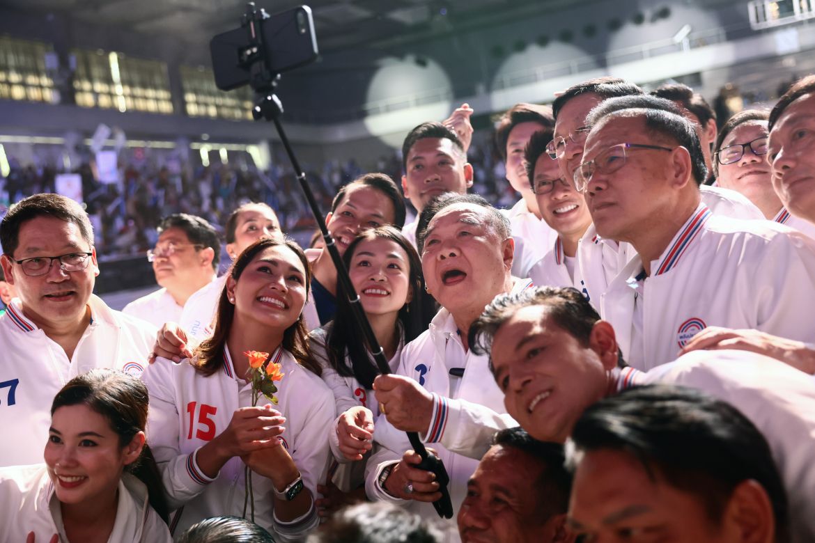 Thailand's Deputy Prime Minister Prawit Wongsuwan and prime minister candidate for the military-linked Palang Pracharat takes a selfie with supporters at the party's final rally