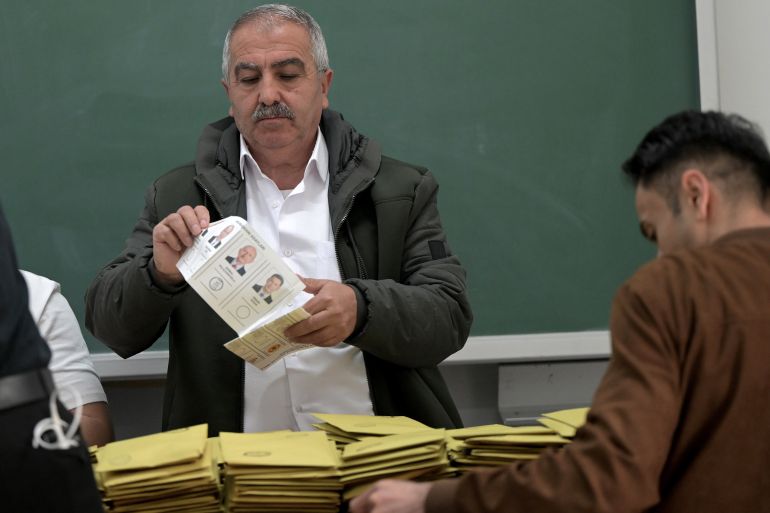 Election officials count ballots at a polling station in Istanbul