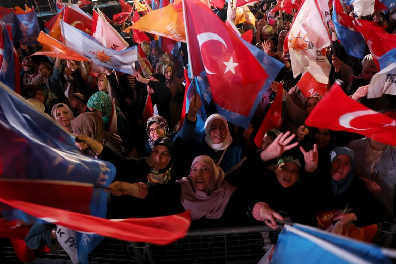 Supporters of Erdogan and his AK party waving flags outside its HQ in Ankara as results come in