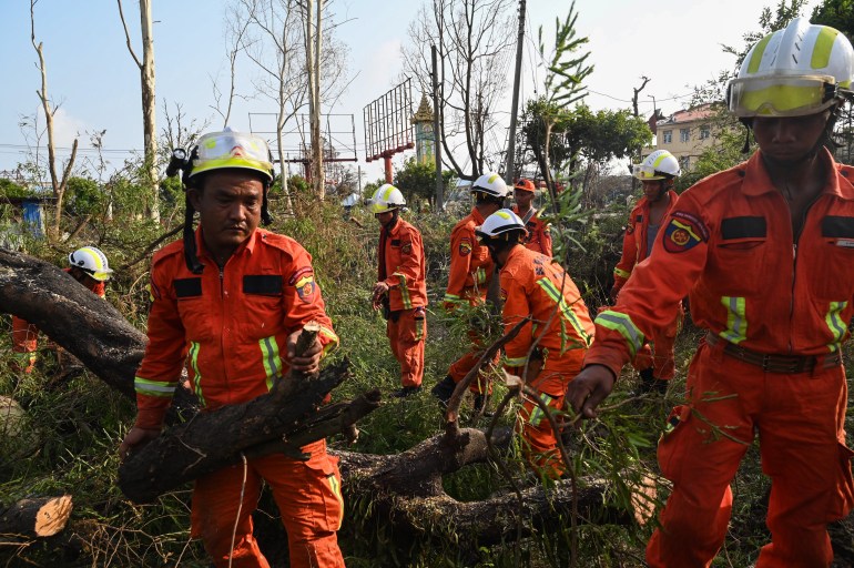 Rescue teams work to remove fallen trees in Sittwe