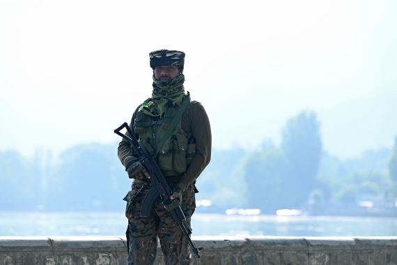 An Indian paramilitary trooper patrols along the shores of Dal Lake ahead of the G20 meeting in Srinagar on May 19, 2023.